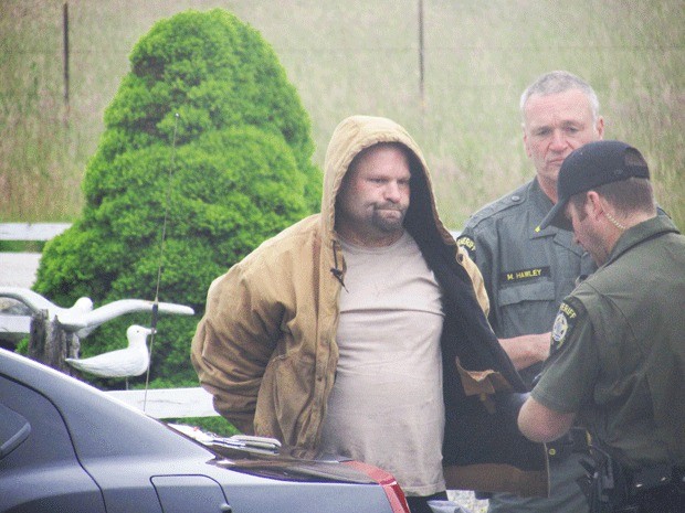 North Whidbey resident Darcy Zook took this photo of deputies arresting rape suspect Douglas Blackburn. He was found hiding in her year not far from her house.