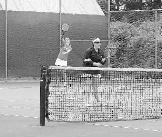 Coupeville’s Jessica Blanchette serves the ball as partner Laura Millhouse waits for a return in Saturday’s title match.