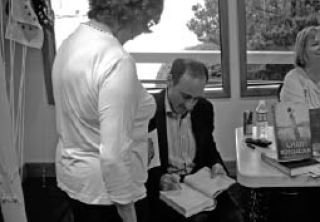 Author Chris Bohjalian signs copies of his book “Midwives” at the Oak Harbor Yacht Club. The book was chosen as Oprah’s book club selection in 1998.