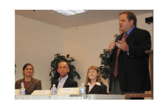 Island County Commissioner Phil Bakke speaks during a candidate night Tuesday sponsored by the League of Women Voters. Looking on are Helen Price Johnson