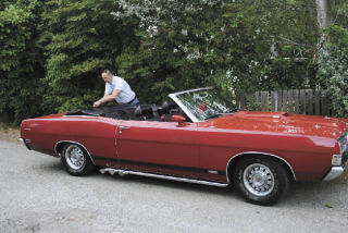 Ray Payeur adjusts the convertible top on his 1969 Torino that will be on display Saturday at the North Whidbey Lions Club Car Show.