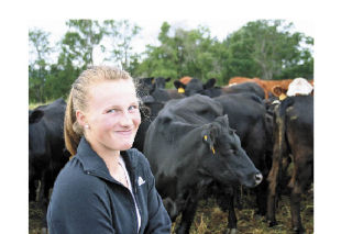 Roshel Muzzall of 3 Sisters Cattle Company looks over some Black Angus cattle. A new marketing effort that will be unveiled in coming weeks should help boost local agricultural products.