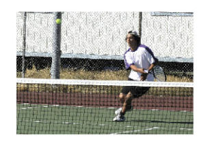 Oak Harbor’s Derek Thomas makes a strong forehand return in Wednesday’s second singles match against Lake Stevens.