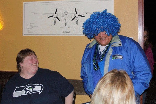 A Seahawks fan admires Oak Harbor Mayor Scott Dudley’s attire at a recent 12th man rally at Flyers Restaurant and Brewery in Oak Harbor.