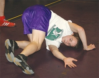 Veteran wrestler Connar Zimmerman demonstrates how to roll out of a hold. Although just a sophomore