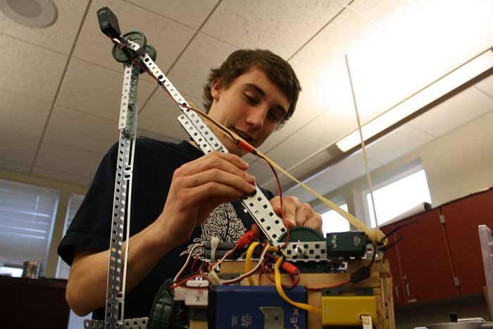 Coupeville High School Senior Zac Forland works on a robotic arm he’s helping design for a Science Olympiad competition next month.