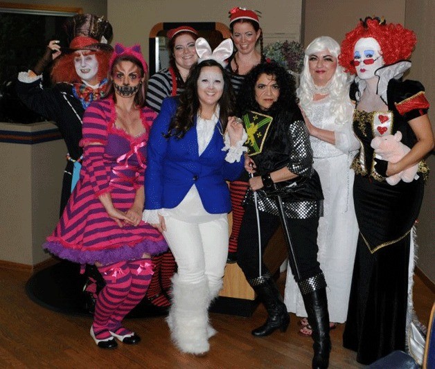 Employees of Carla’s Shear Inspiration dressed up for Halloween to raise money for food banks. From left in the back row: Val Jernberg as the Mad Hatter