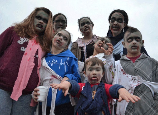 A family prepares to take over Midway Boulevard for the Zombie Crawl Saturday