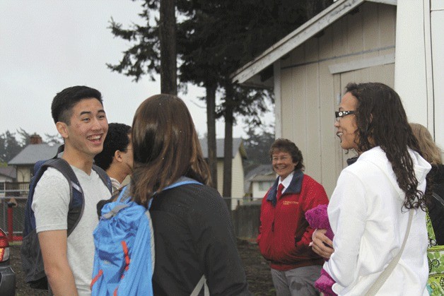 Members of the Oak Harbor High School culinary arts program wait to board a shuttle to the airport Thursday morning. Seven students took a flight to Baltimore