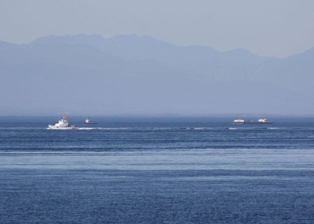 A U.S. Coast Guard vessel passes Saturday