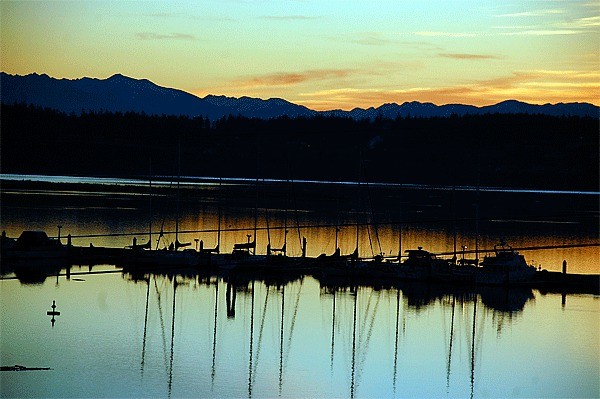 The sun sets over Oak Harbor Marina. The facility’s occupancy is dropping and officials hope abandoning a scheduled rate hike will help address the issue.