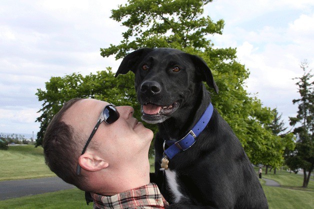 Gary Daugherty cradles his canine companion