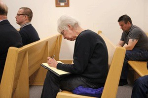 Freeland resident Shirley Hickman takes notes at a murder trial for her friend
