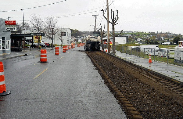 Strider Construction workers pulverize Pioneer Way between Dock Street and Midway Boulevard Monday morning. All work will stop Thursday and the street will be prepped for Holland Happening.