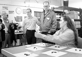 Cameo LaForest shows off an assortment of tiny valves manufactured by Upchurch Scientific. Standing next to her is Don Mulkey