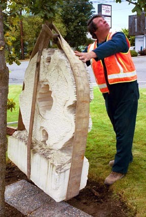 City employee Ron Nye places “The Journey Home” in its new location next to City Hall a few days prior to the July 4 installation ceremony presided over by Mayor Patty Cohen. The limestone sculpture by Doug Neil was donated to the city last week by Dorothy Neil. It can be seen on the front of City Hall in its permanent location next to three Garry oak trees earlier donated by Neil.