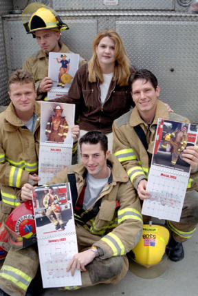 Firefighter calendar creator Tammi Spinner is surrounded by a few of her models