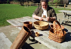 Karen Sherwood works on making a cord from bark