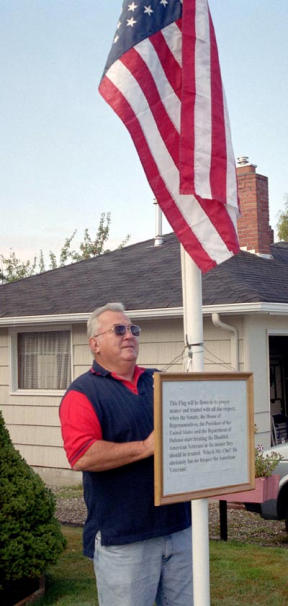 Oak Harbor resident and disabled American veteran Bob Barber hopes his distress signal of an upside-down American flag will draw attention to the fight over concurrent receipt disabled American veterans are waging with the Bush administration.