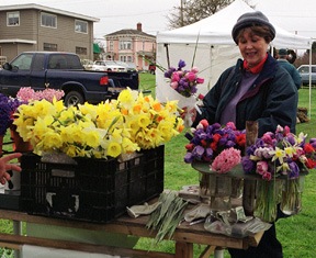 Gayle Hassler selects a spring bouquet at Coupeville Farmer’s Market.