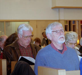 Oak Harbor resident Bruce Brown prays during St. Augustine’s vigil for peace Wednesday.