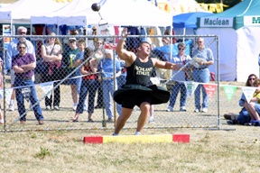 Jeremiah Strand gives the stone a hefty heave in Saturday’s Scottish Highland Games in Greenbanks. Strand was the overall winner in the amateur division.