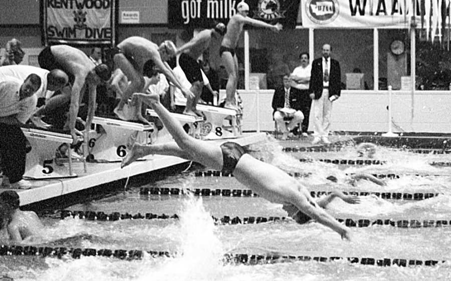 Oak Harbor’s Jason Hunter dives in for his anchor leg of the 200 freestyle relay consolation heat at the 4A state meet last weekend. Below right: Senior David Swoish checks out the scoreboard after his preliminary race in the 100 freestyle. Swoish posted a time of 49.48 and moved onto the finals where he took seventh place.