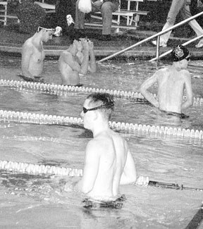 Oak Harbor and Cascade swimmers keep warm waiting for their meet to resume after the diving part of the competition.