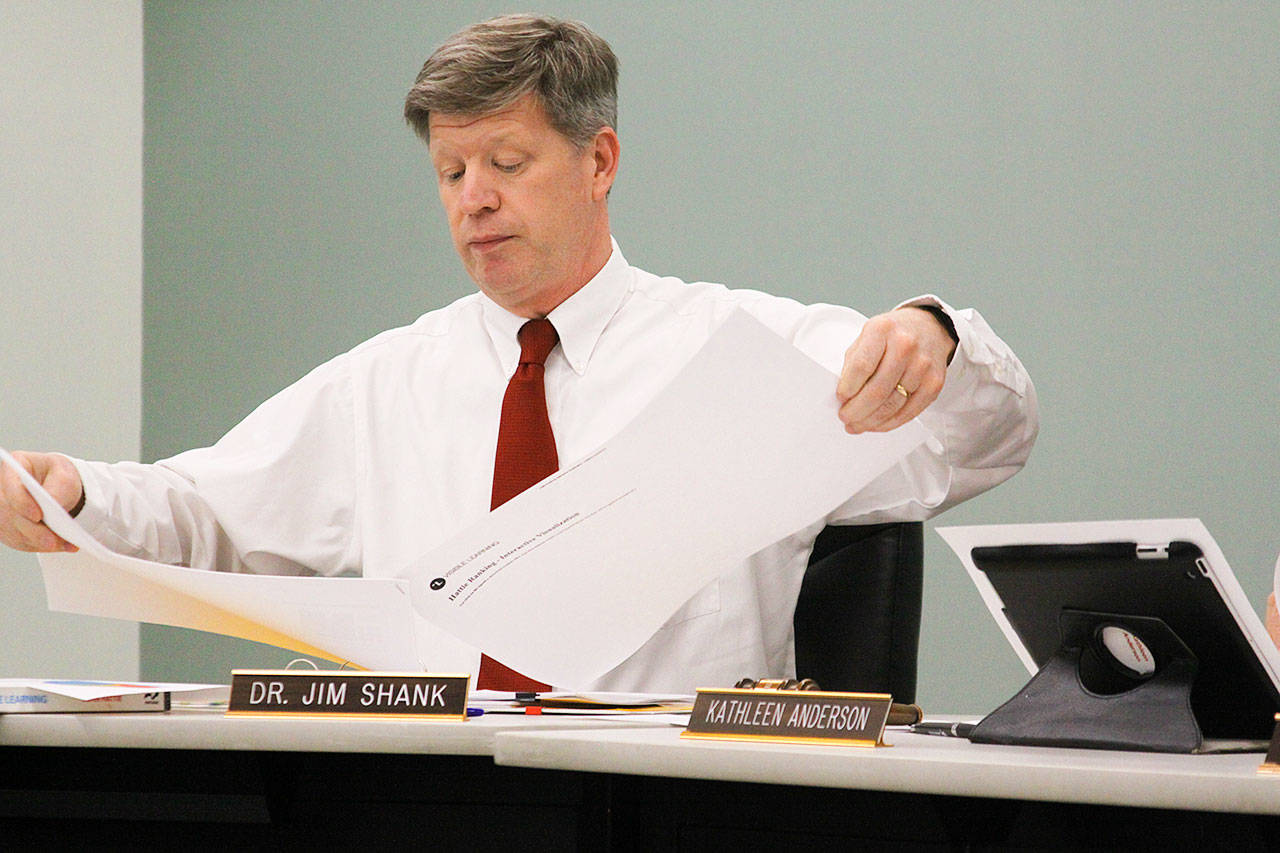 Coupeville School District Superintendent Jim Shank looks over plans at a school board meeting. Shank is a finalist for the superintendent post in Twin Falls, Idaho. Photo by Ron Newberry