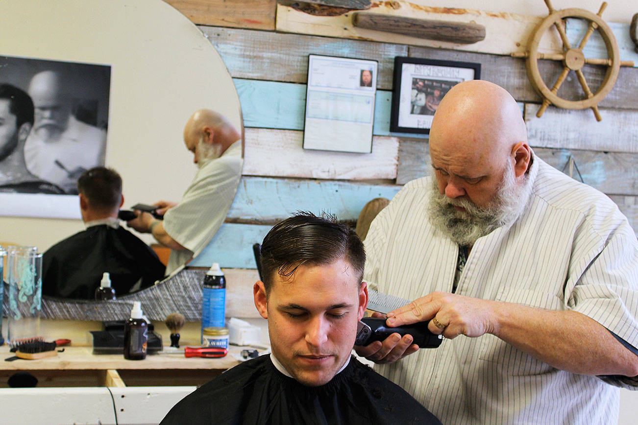 Photos by Patricia Guthrie/Whidbey News-Times                                Petty Officer 2nd Class Joshua Grant gets a close cut known as a fade from barber Kevin Bell recently. Bell specializes in haircuts for men in the military and what he calls “rockabilly” styles.