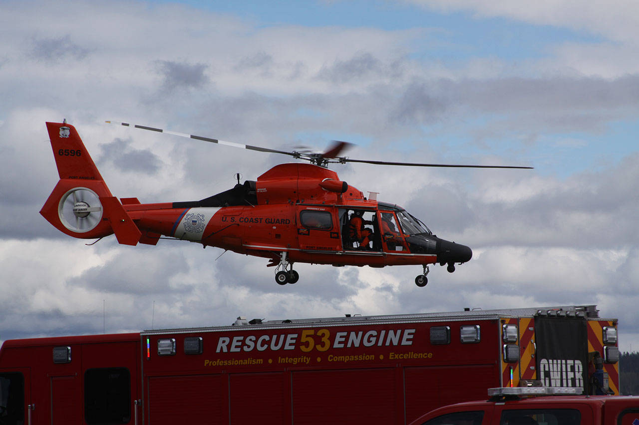 The U.S. Coast Guard helicopter departs from the Keystone Spit portion of Fort Casey State Park after a false alarm involving a diver at the underwater park. A number of other emergency responders arrived as well after someone spotted the diver entering the water in jeans and a sweatshirt and was concerned when he didn’t surface. The diver had a wet suit underneath. Photo by Ron Newberry/Whidbey News-Times