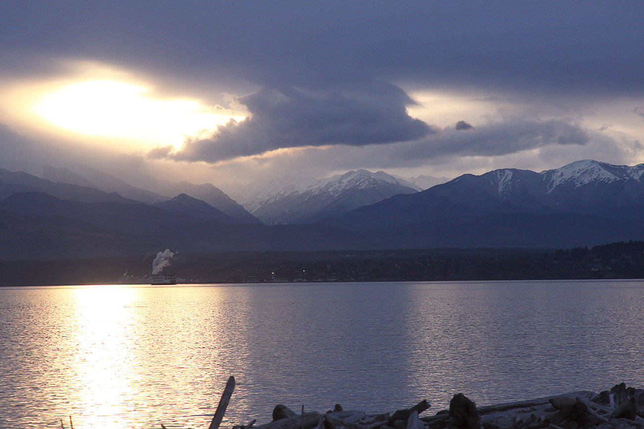 A look out over Admiralty Inlet on the west side of Whidbey Island on a gloomy January 2017 late afternoon reveals a peek at the Olympic mountains, the source of the area’s rain shadow. Photo by Ron Newberry/Whidbey News-Times.