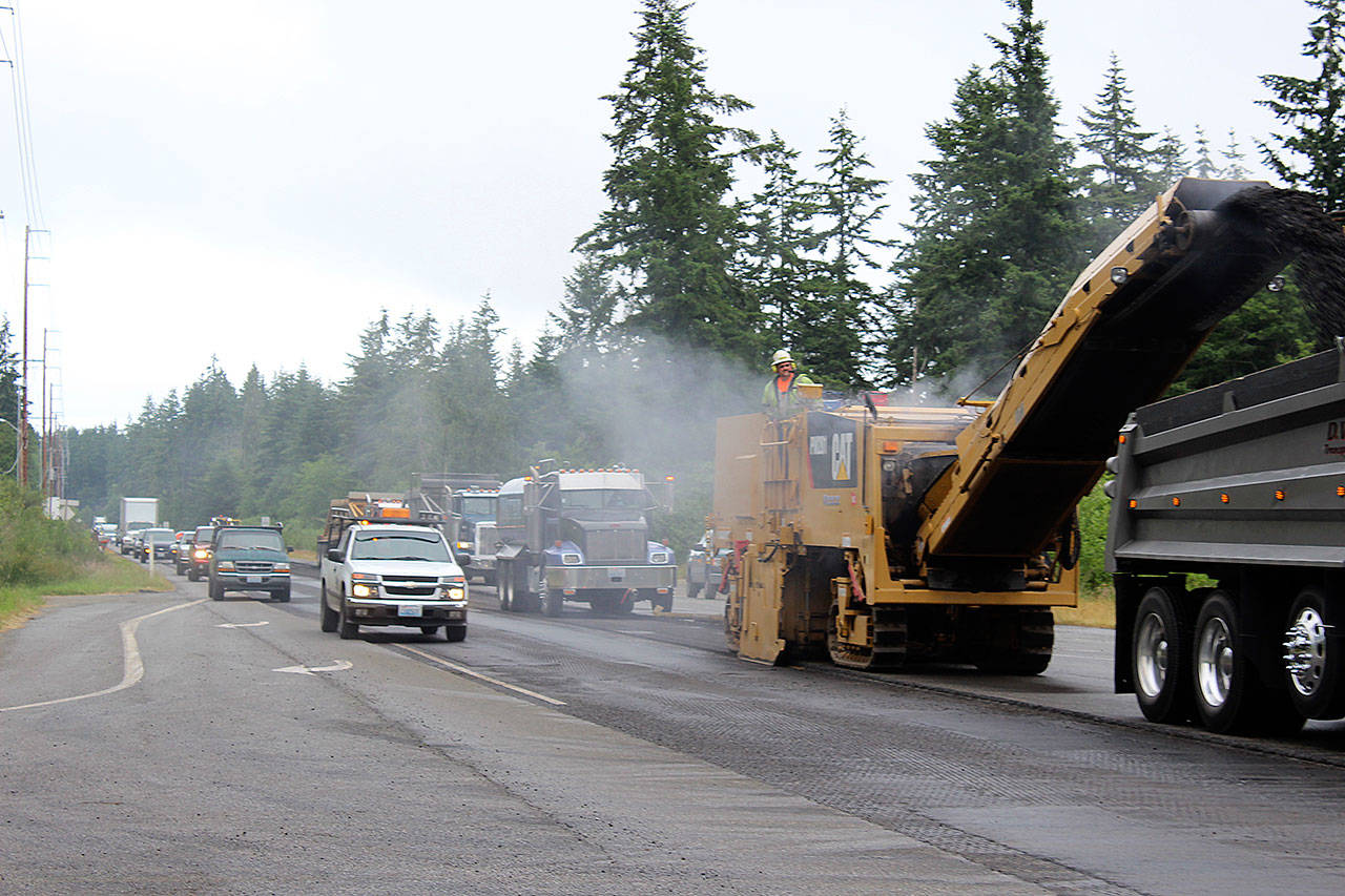 Road crews will be out all summer repaving more than 30 miles of Highway 525/State Highway 20 from Coupeville to Clinton. Drivers should allow an extra 30 minutes for their trips and to catch ferries. Crews worked near the intersection of Classic Road and HIghway 525 Tuesday morning putting down new asphalt. Photo by Patricia Guthrie/Whidbey News-Times