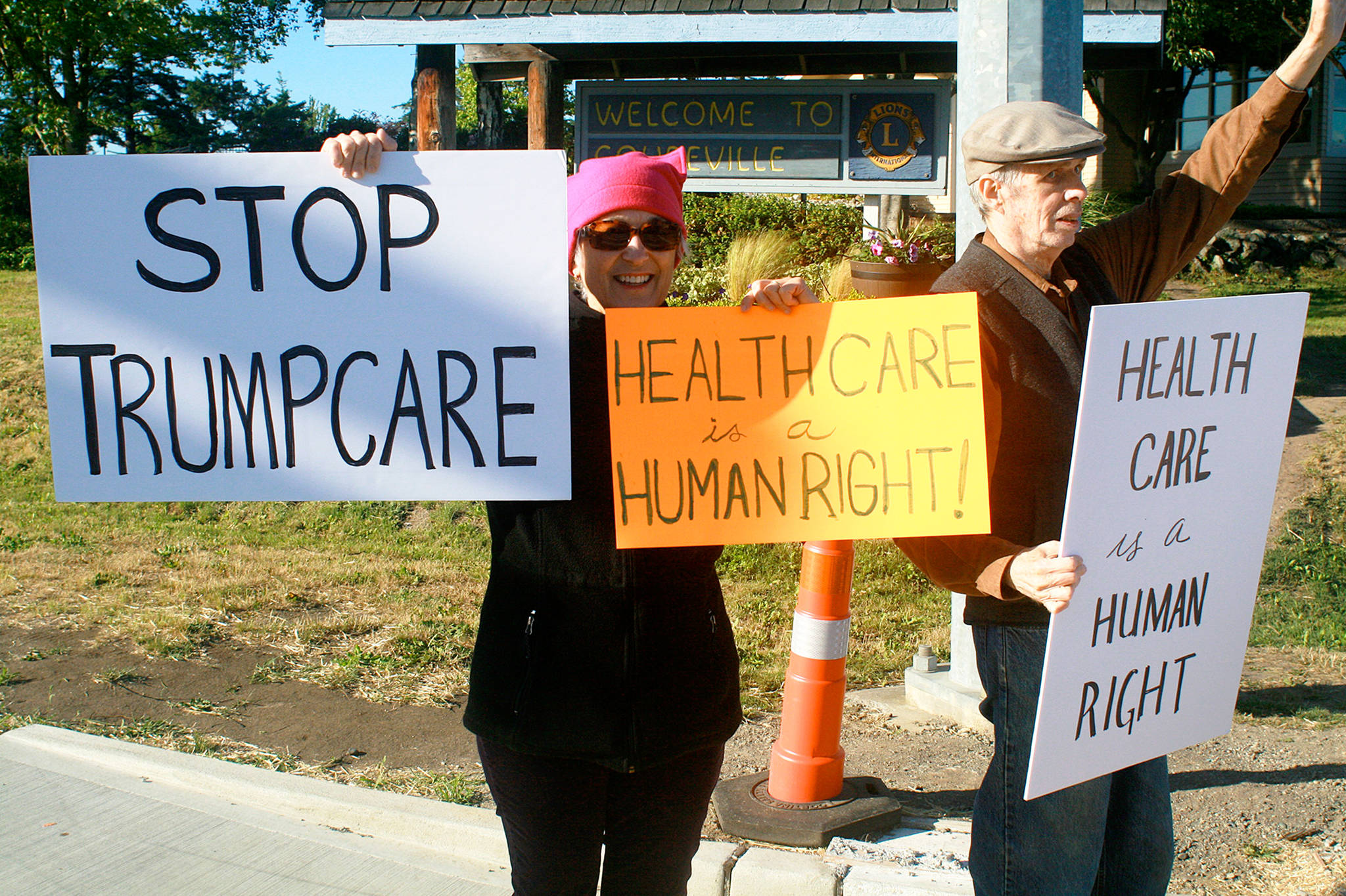 Oak Harbor resident Jane Janehning, left, and Clinton resident Malcolm Cummings protest the coming of Trumpcare as part of a protest vigil Tuesday in Coupeville. Photo by Daniel Warn/Whidbey News-Times