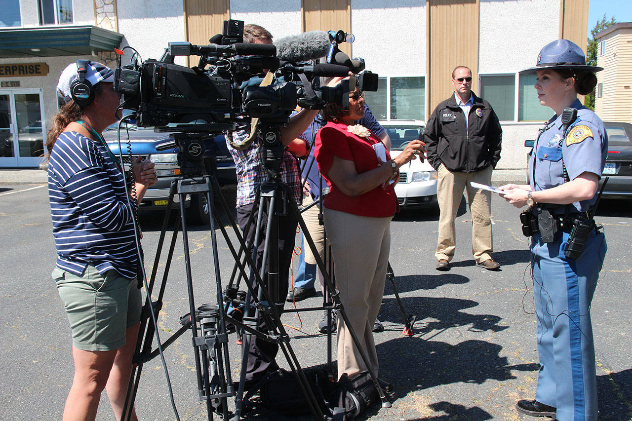 Washington State Trooper Heather Axtman speaks with TV reporters about an officer-involved shooting in Oak Harbor. Oak Harbor Police Chief Kevin Dresker is in the background. Photo by Daniel Warn/Whidbey News-Times