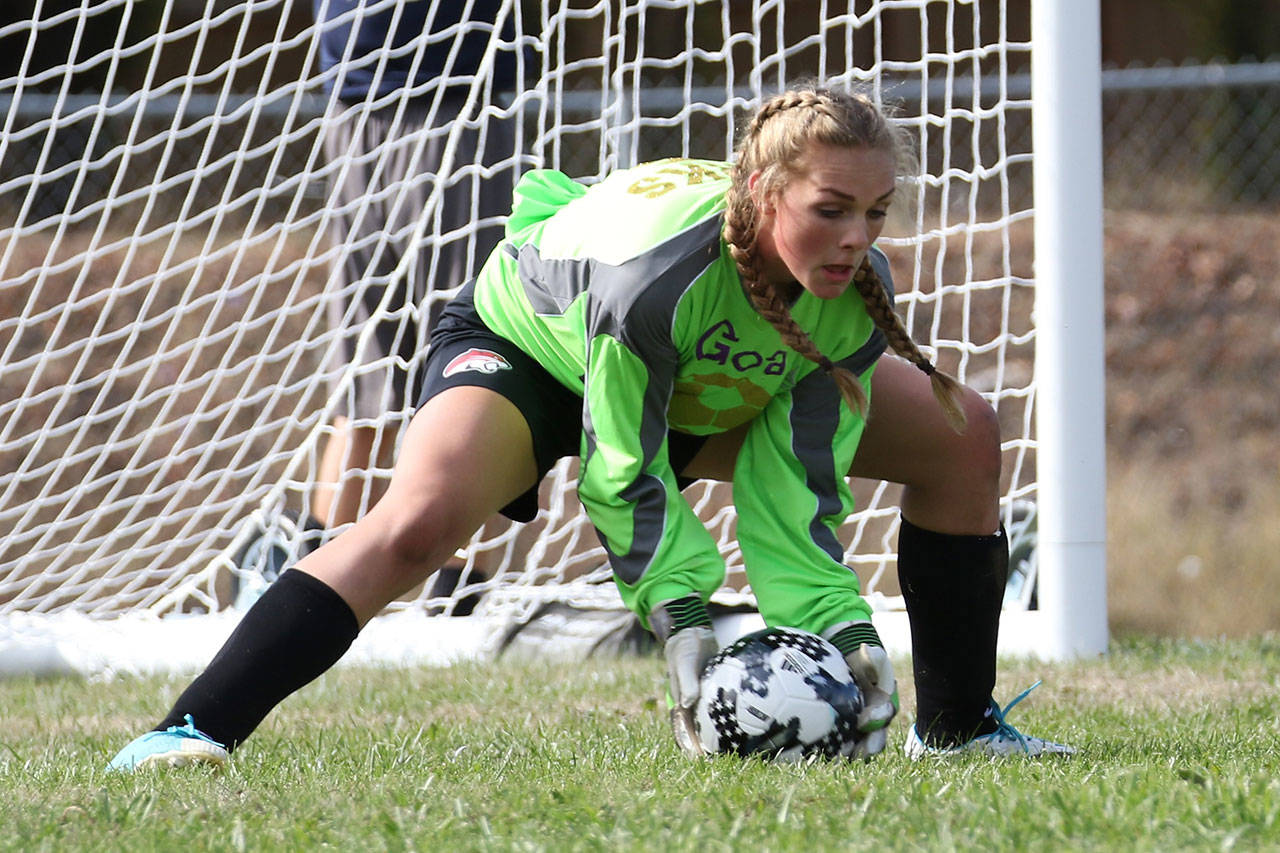 North Whidbey goalie Payton Parks scoops up a Stanwood shot. (Photo by John Fisken)