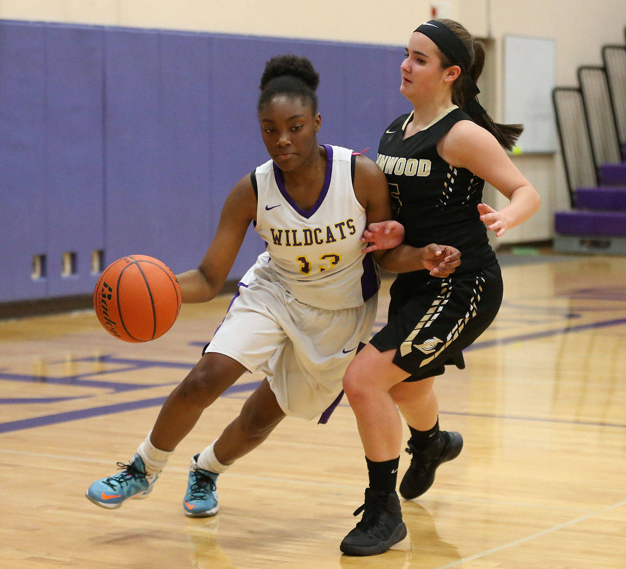 Delija Cammon, left, drives by Lynnwood’s Emily Whybark. (Photo by John Fisken)