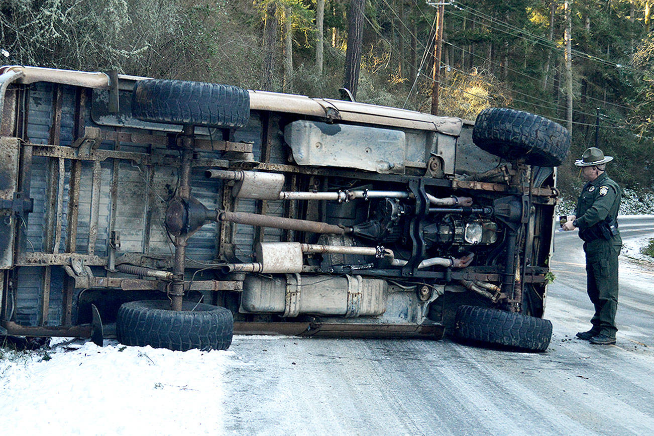 Man uninjured in rollover on icy Madrona Way