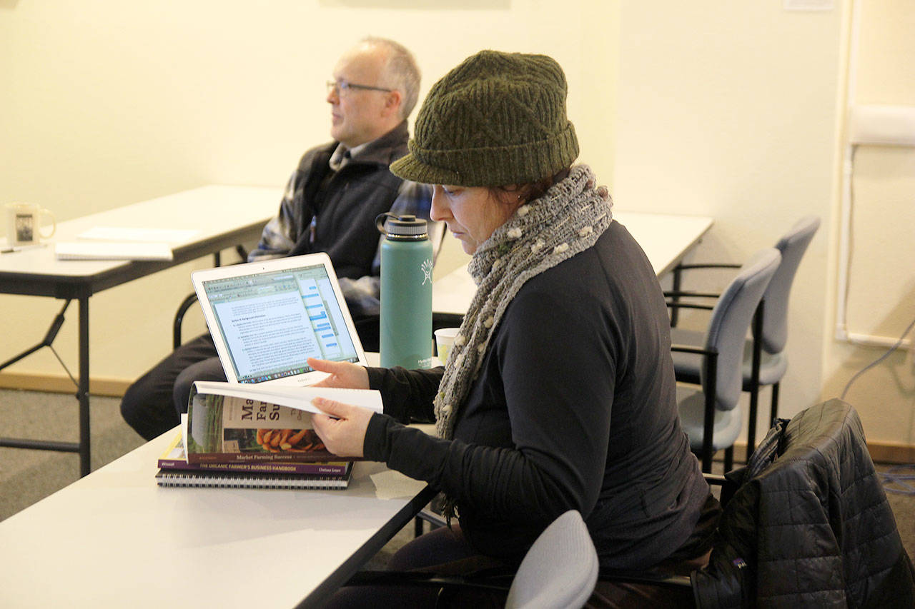 Melissa Correia participates in Washington State University Extension, Island County’s Cultivating Success class. Loren Imes, facilitator of the class, sits behind her. A new contract restructuring the university’s relationship with the county will allow the extension to increase its programming by 20 percent. Photo by Laura Guido/Whidbey News-Times