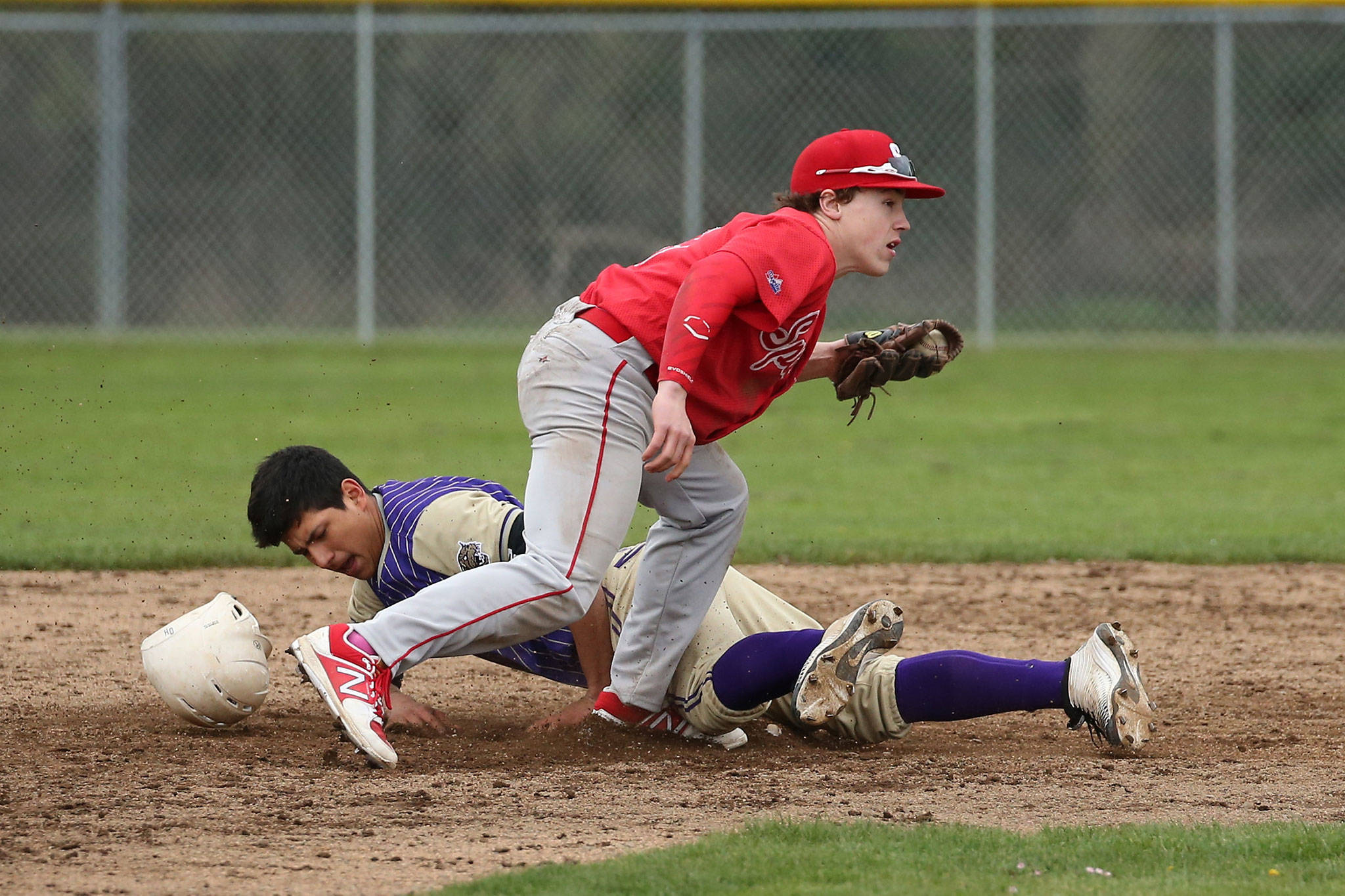 Aaron Martinez steals second base ahead of the tag by Stanwood second baseman Nick Deline. (Photo by John Fisken)