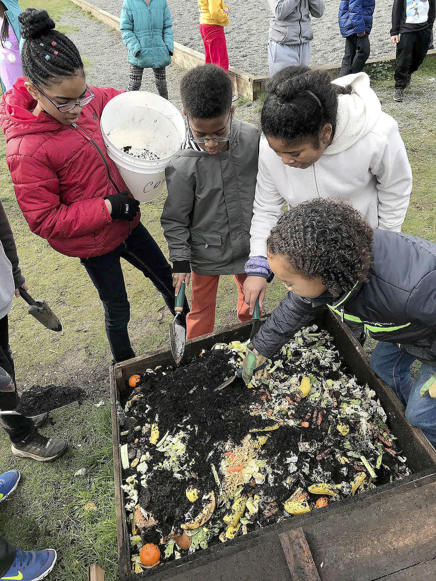 Broad View Elementary School students from left, Angela Allen, Anton Rayner, Nika Jones and J’Den Ceya McCrea work in the school’s compost bin. Broad View was recently named a national Green Ribbon School for its environmental work.