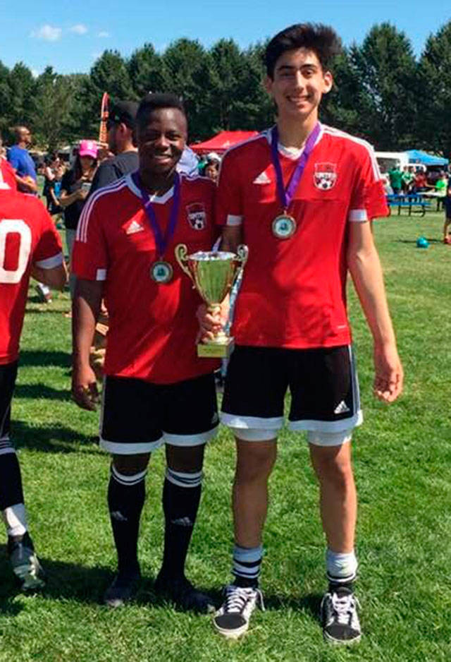 Matt Kelley, right, and teammate Nathan Berg of Lynden show off the trophy they won at the Firecracker Championships. (Photo by Diane Kelley)