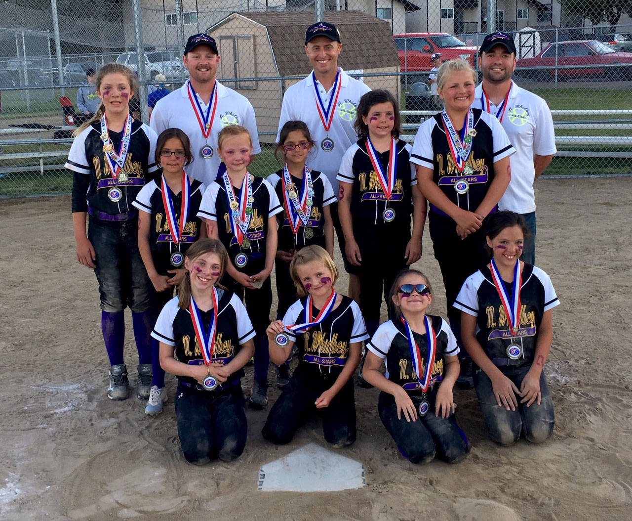 The members of the North Whidbey Little League 8-10 softball team show off their fifth-place medals from the state tournament. Back row, left to right: coaches James Regan, Brian Wasinger and Brandon Vaughn. Middle row: Reese Wasinger, Keli Aranguri-Plummer, Mia Regan, Olivia Aranguri-Plummer, Joelle Hassler and Alexis Black. Front row: Emily Hills, Ava Shoosmith, Addison Christie and Piper Lanning. Not pictured, Scarlett Nations. (Submitted photo)