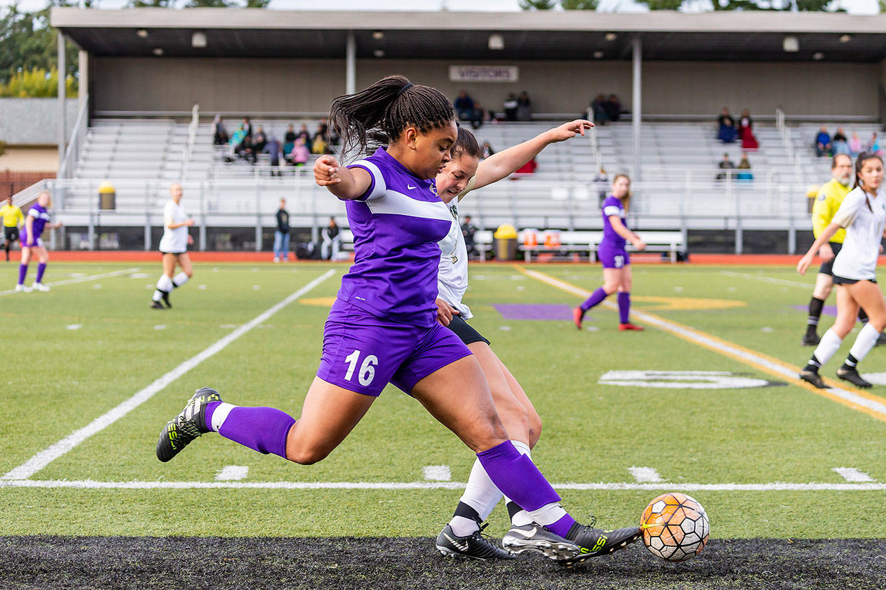 Oak Harbor’s Tiana Jackson (16) beats a Marysville Getchell player to the ball in Saturday’s match. Jackson tallied two goals in the Wildcats’ 4-1 win.(Photo by John Fisken)