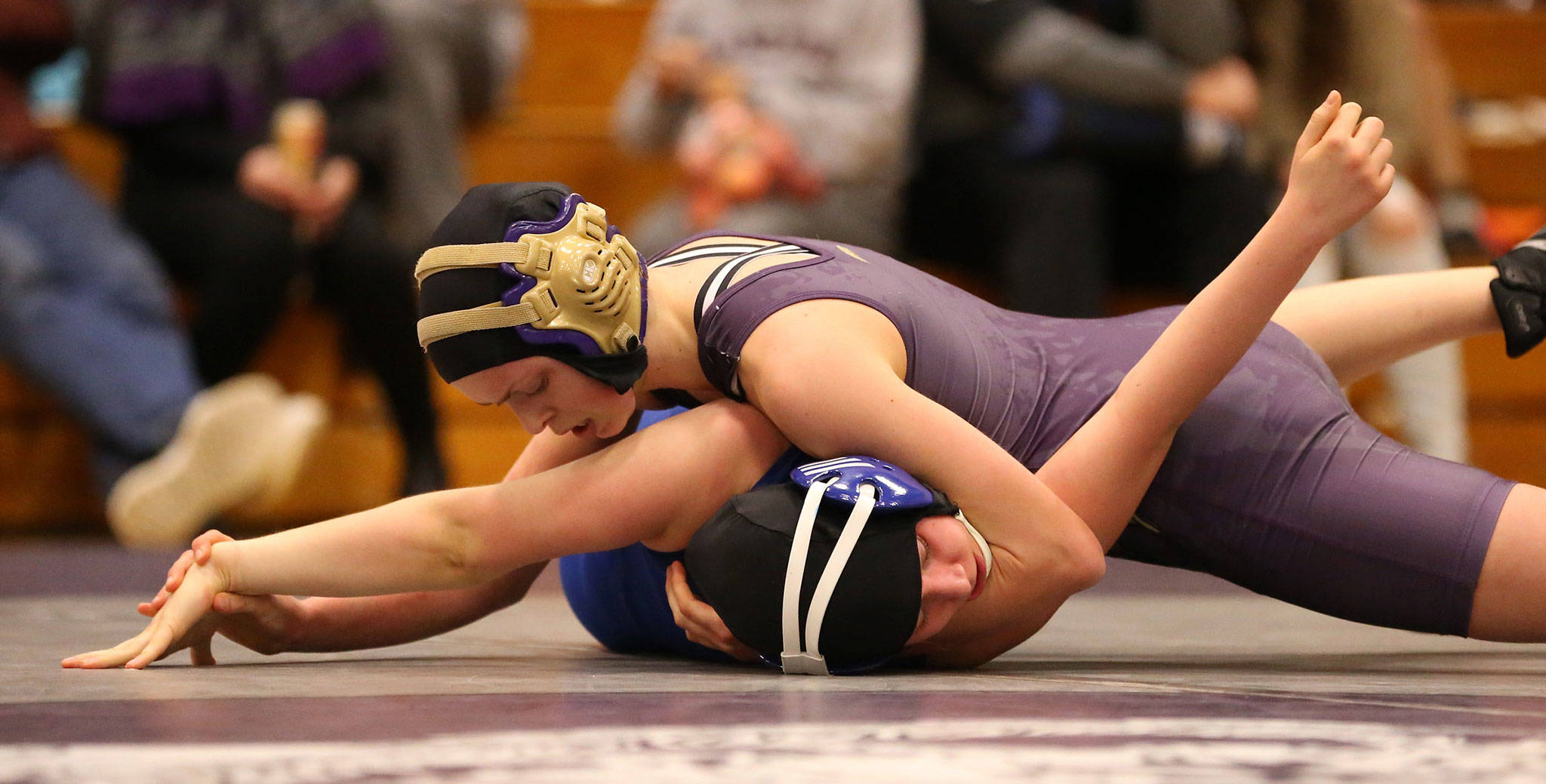 Oak Harbor Ella Erikson, top, pins Ingrham’s Laina Goss at the Lady Knights Invitational Saturday. (Photo by John Fisken)