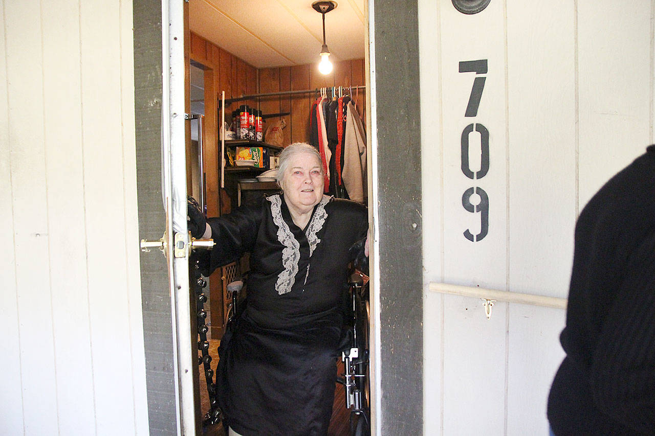 Kathy Longan bids farewell to Meals on Wheels volunteer Susan Myers. Longan, like many of the program’s recipients, is mostly housebound. Isolation is major issues facing Island County seniors, according to staff from Island Senior Resources. Photo by Laura Guido/Whidbey News Group