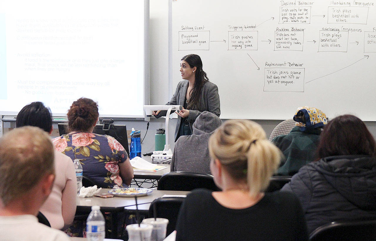 Photo by Laura Guido/Whidbey News-Times                                Casey Dyckman, a behavior analyst, gives a presentation about consequence interventions for children with autism spectrum disorder at a free workshop held by Autism Partnership of Island County.