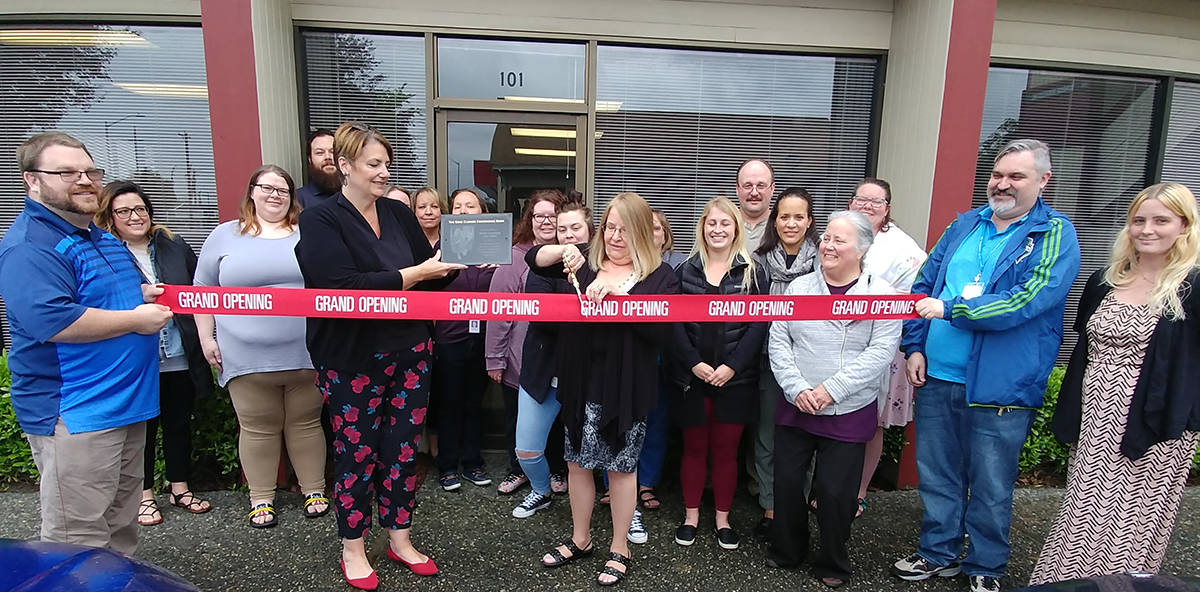 Staff celebrate the opening of the Gene Closser Conference Room, part of Sunrise Services’ substance use disorder recovery program in Everett.