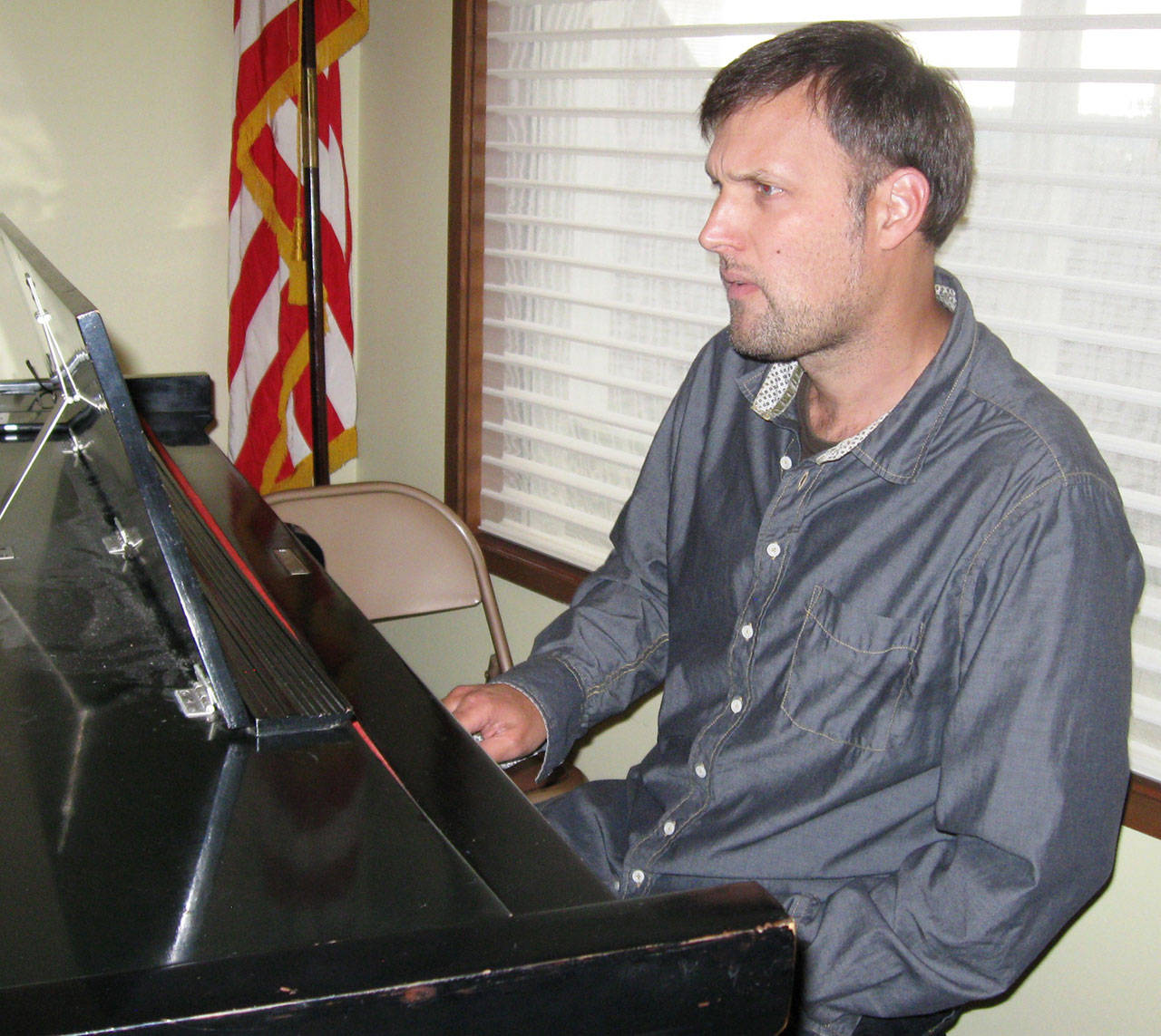 Jazz/classical pianist Rich Pellegrin sits at the concert grand piano at Langley United Methodist Church. Photo by Dave Felice