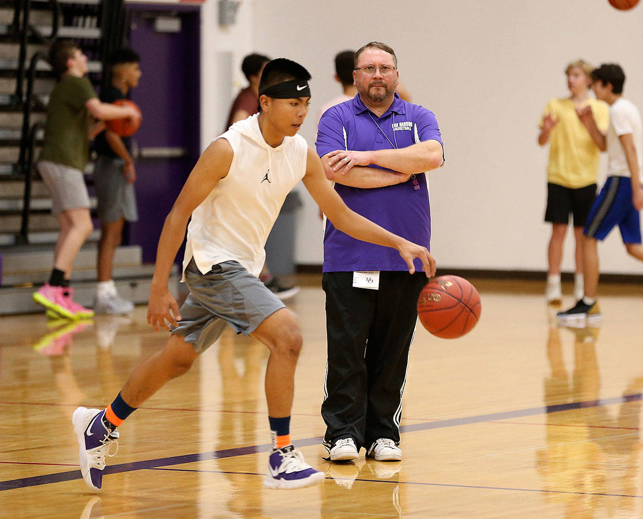 New coach Nate Sullivan watches drills at an Oak Harbor practice earlier this week. (Photo by John Fisken)